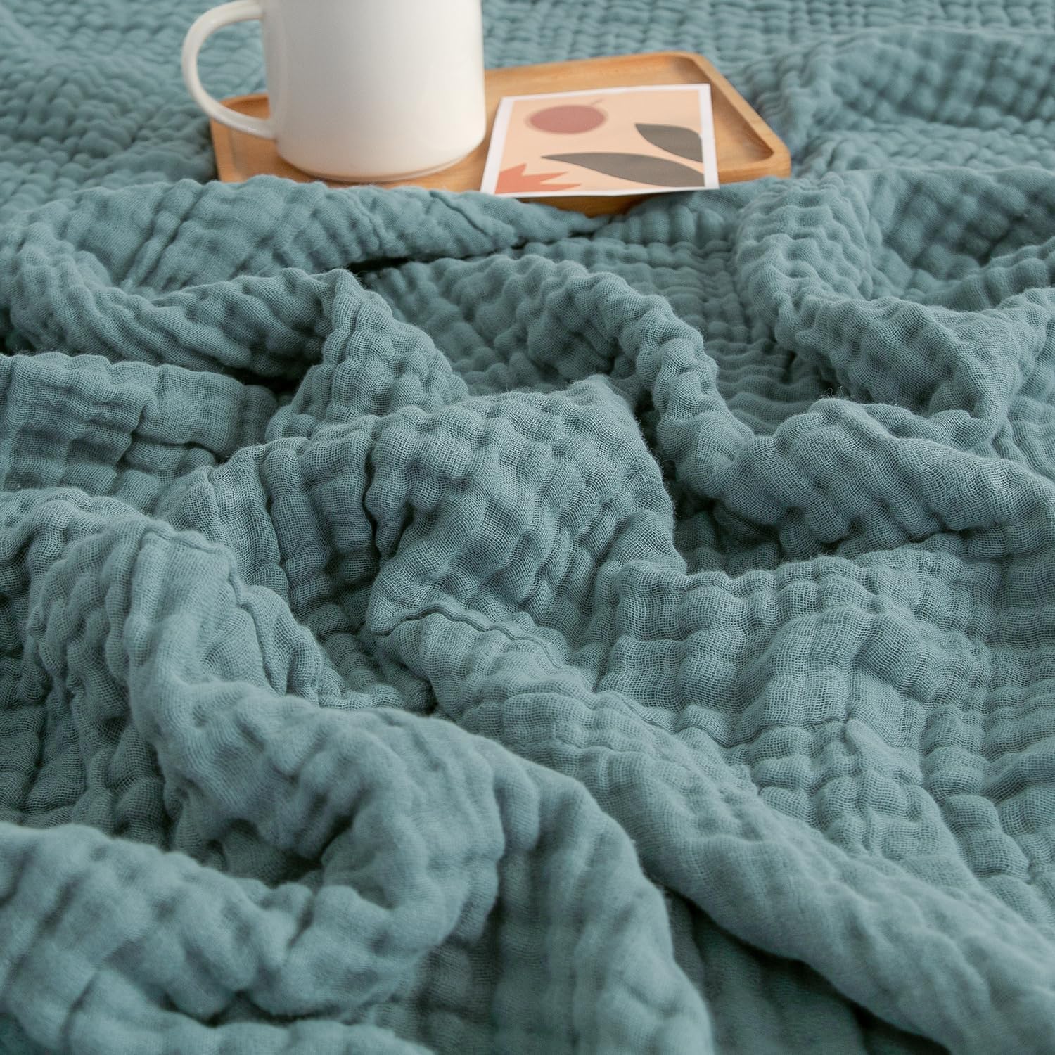 EMME Muslin Throw Blanket in teal with four-layer cotton gauze construction