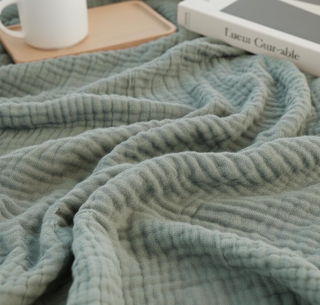 KyraHome organic cotton throw blanket in sage green with natural plant-based dye