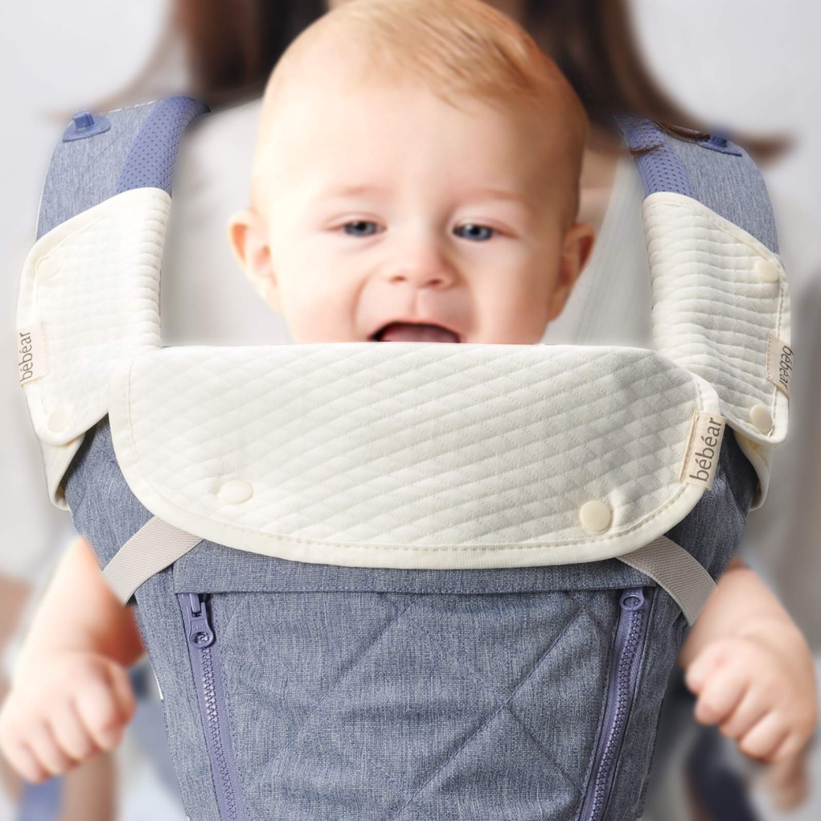White reversible cotton carrier bib set with front pad and two strap covers laid flat