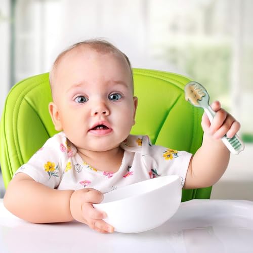 Baby using NumNum pre-spoon showing proper grip technique