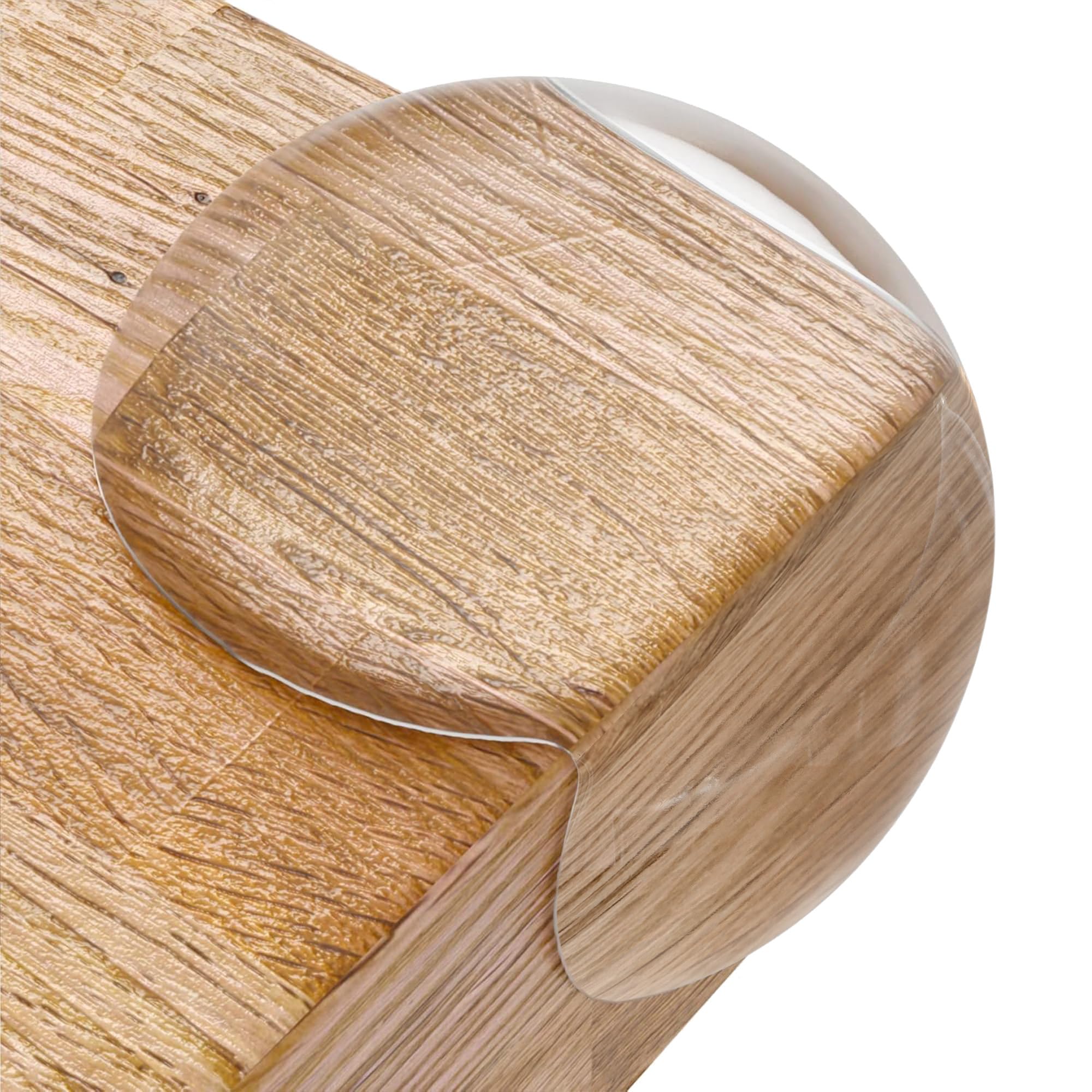 Clear corner protectors attached to furniture edges for baby safety